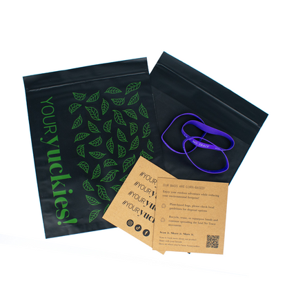 Plant-based black and green patterned bags. Back side has a black pocket. Three purple earth-friendly bands. An earth-friendly information card #YourYuckies with a description of the product on the others side. 